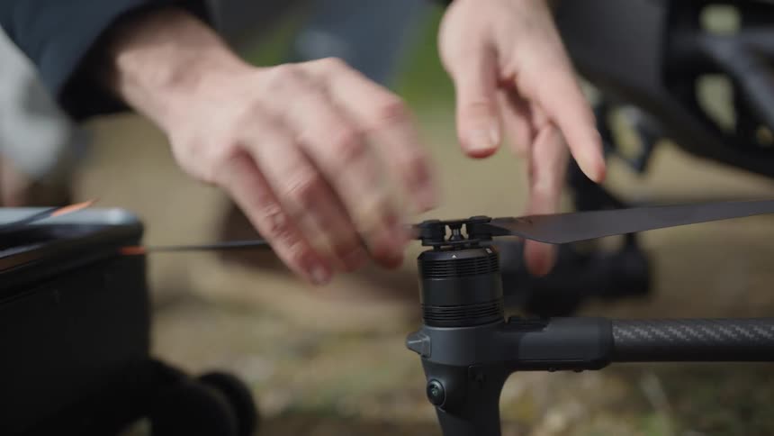 Man attaches drone blades