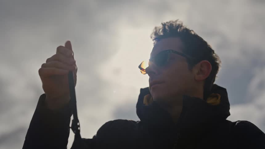 Man on glasses holds a drone blade and cleans its tip