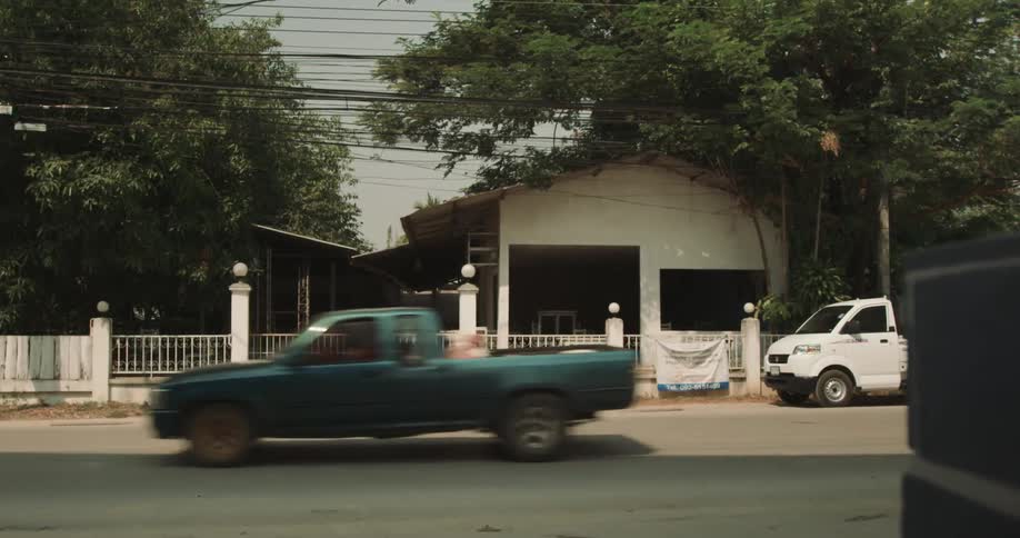 Exterior of a small white house in a quiet neighborhood