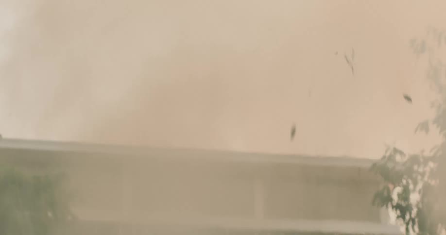 A closeup of intense fire and smoke billowing in an urban environment