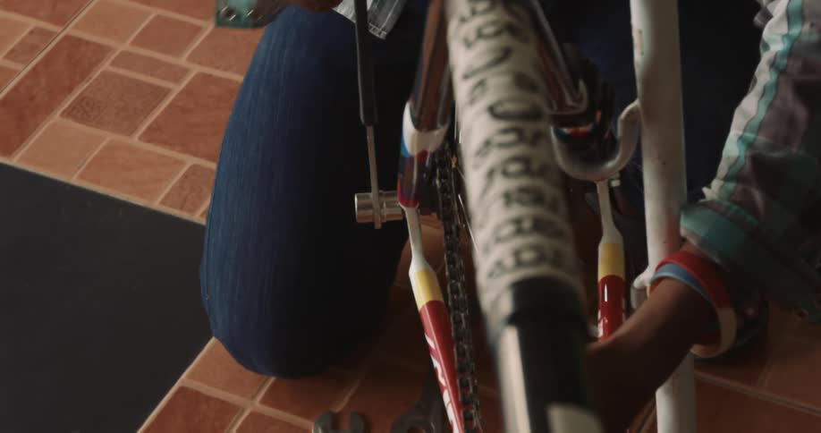 Hands of a person adjusting the wheel of a bicycle