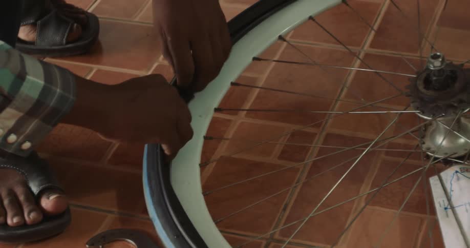 A person fixing a bicycle tire at home