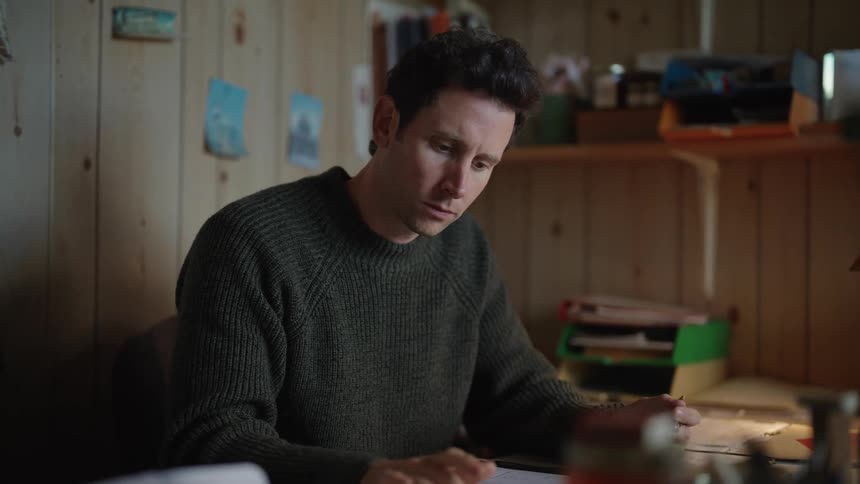 Man sits at desk calculating finances