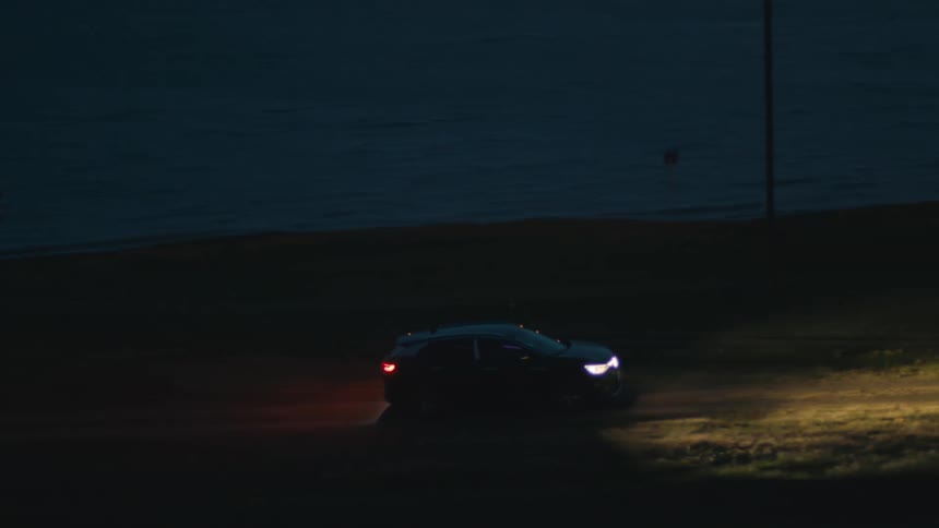 Car driving on country road at night