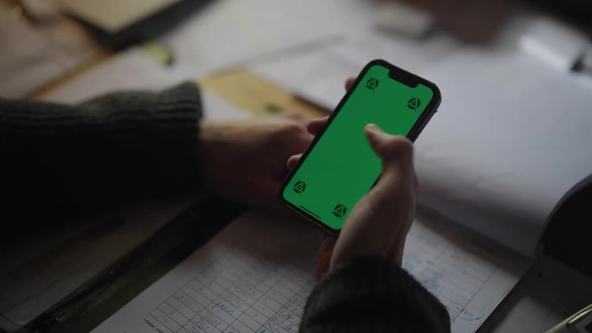 A hand of a person using a smartphone
