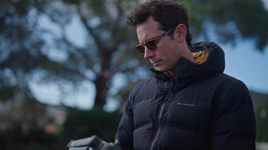 Man opens case and removes remote controller outdoors