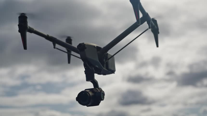 Drone hovering in the sky on a cloudy day