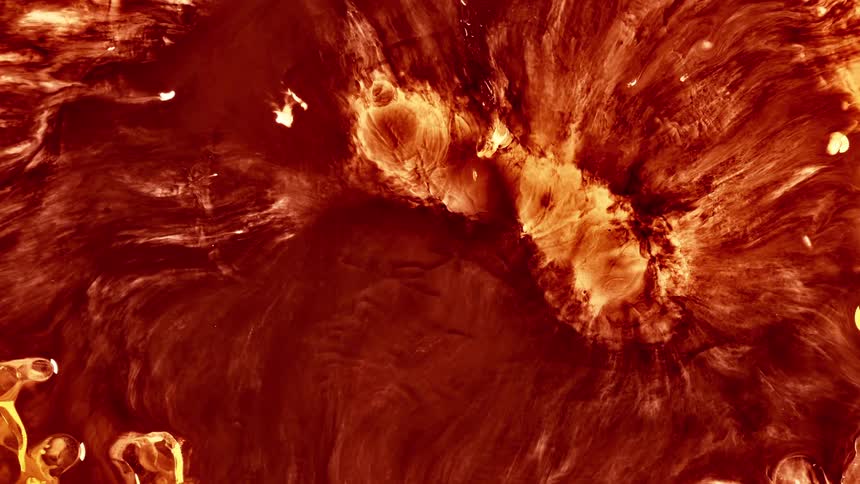 A liquid and abstract form of orange and red color is expanding