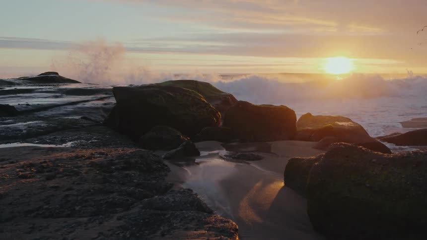 A video of a rocky shoreline captured by sunrise