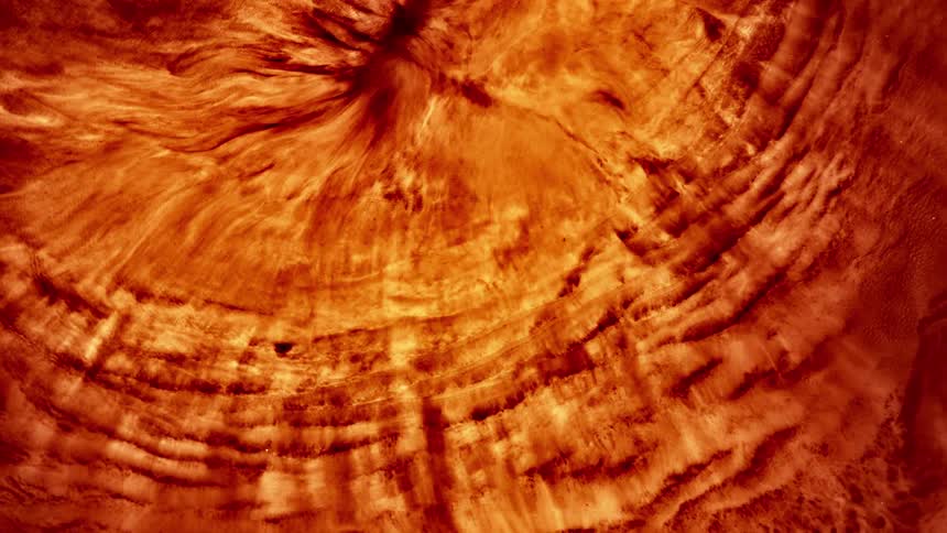 Abstract liquid in motion with a reddish hue
