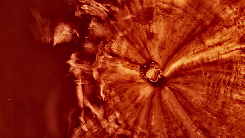 An object with flames and fire is contracting to a small hole in its center