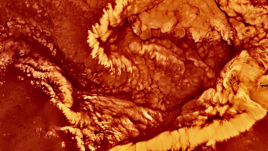 Red and orange liquid resembling lava flowing in abstract shapes