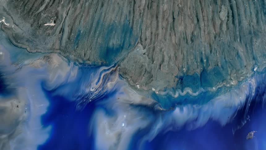 Waves with white foam in the blue sea