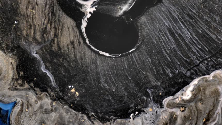 A black viscous liquid is falling into an environment with several colored liquids