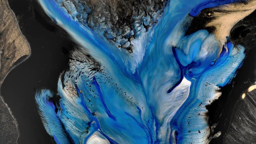 Aerial of the blue sea with black sand on the coast