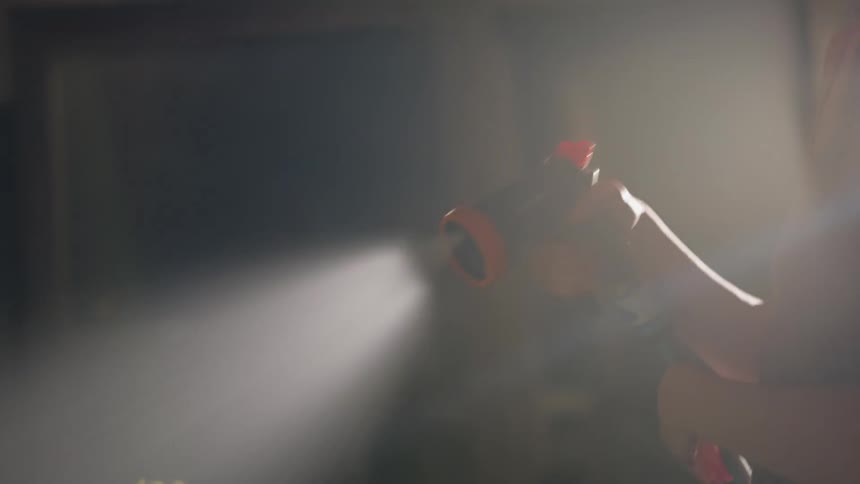 Woman waters an indoors garden with a hose at morning