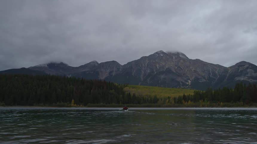 A person is rowing forward in the water