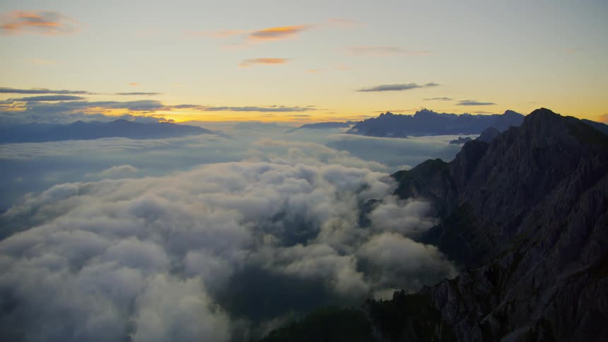 An airy view of the mountains that is at the top of the clouds