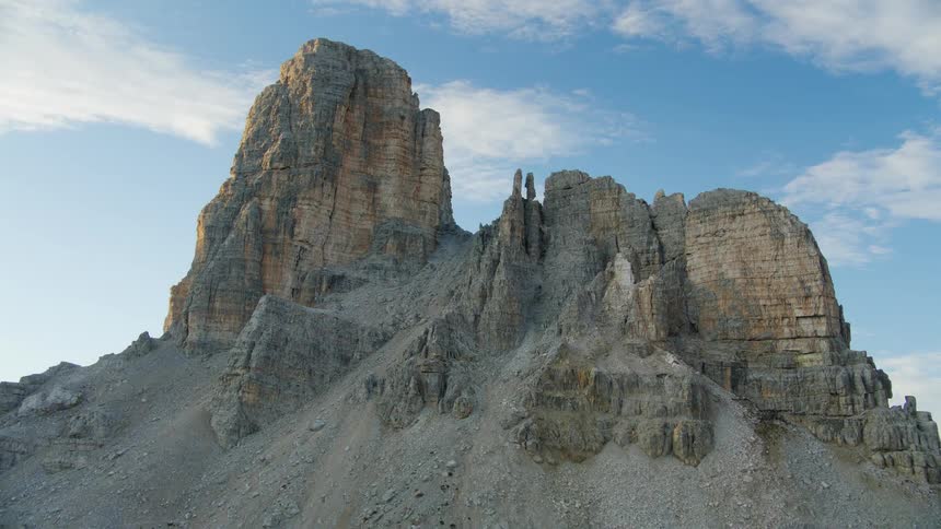 A mountain of rocks on a hill and behind several other mountains