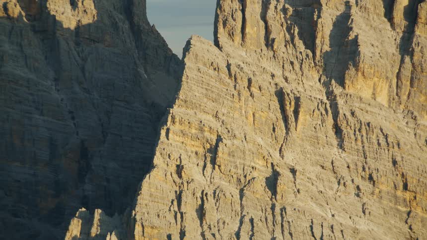 Shadows fill gap between sheer mountains on cloudy day