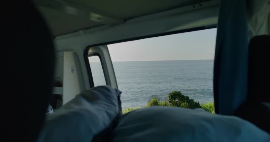 A view from inside a vehicle of the sea with waves in motion