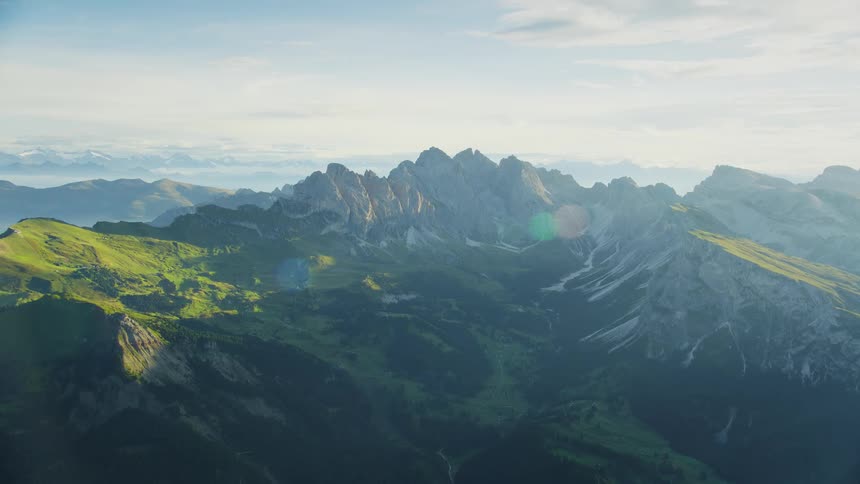 A landscape with a huge mountain in the background and a valley in the middle