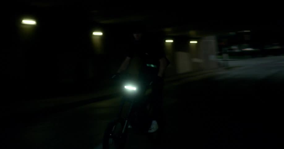 A man riding a motorcycle at high speed in the urban city