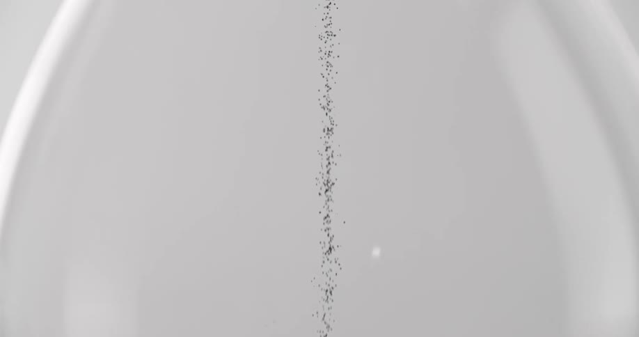 An hourglass with some grains of sand falling from the top