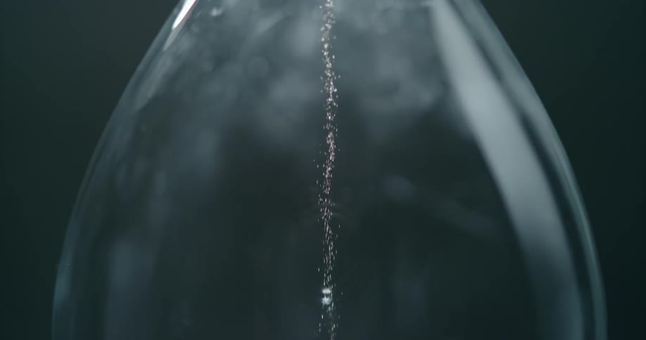 The sand slowly falls through the hourglass