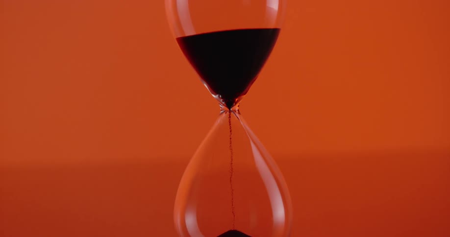 Time hourglass with black sand falling