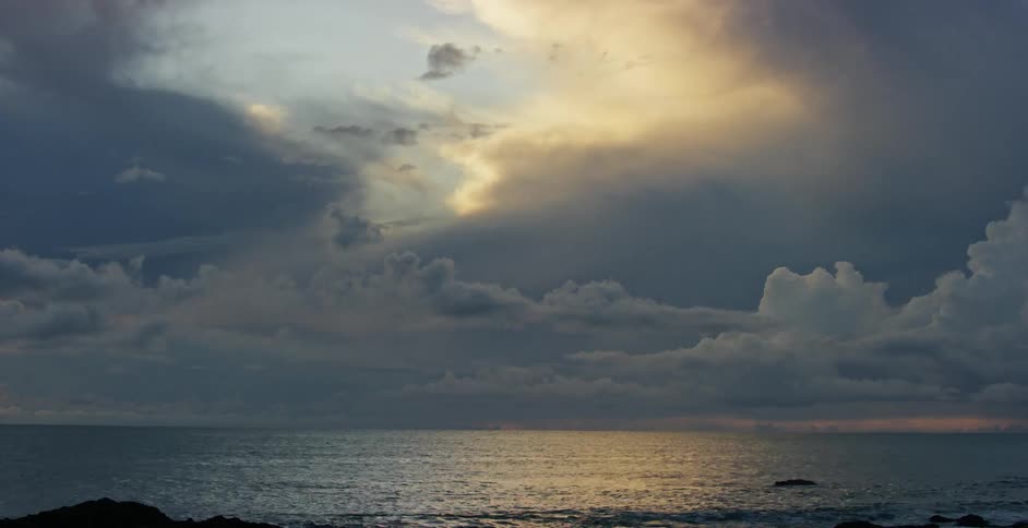 The clouds pass over the ocean at sunrise