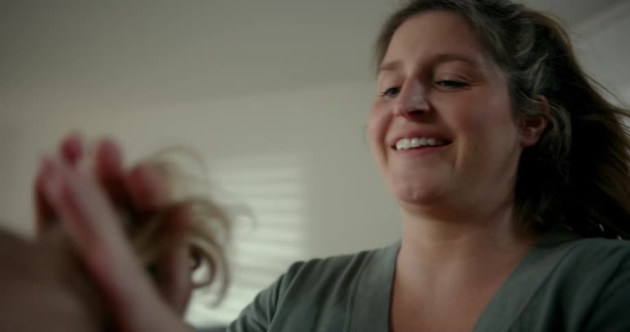 A mother making her daughters hair