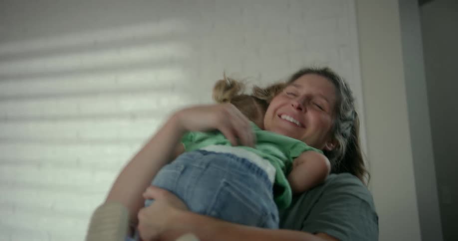 A mother and her daughter share a hug