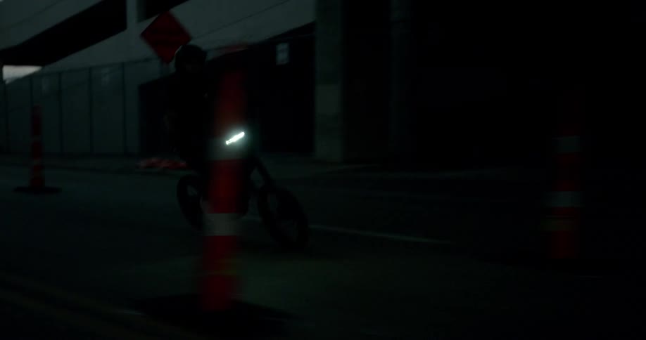A man rides his dirt bike through the city