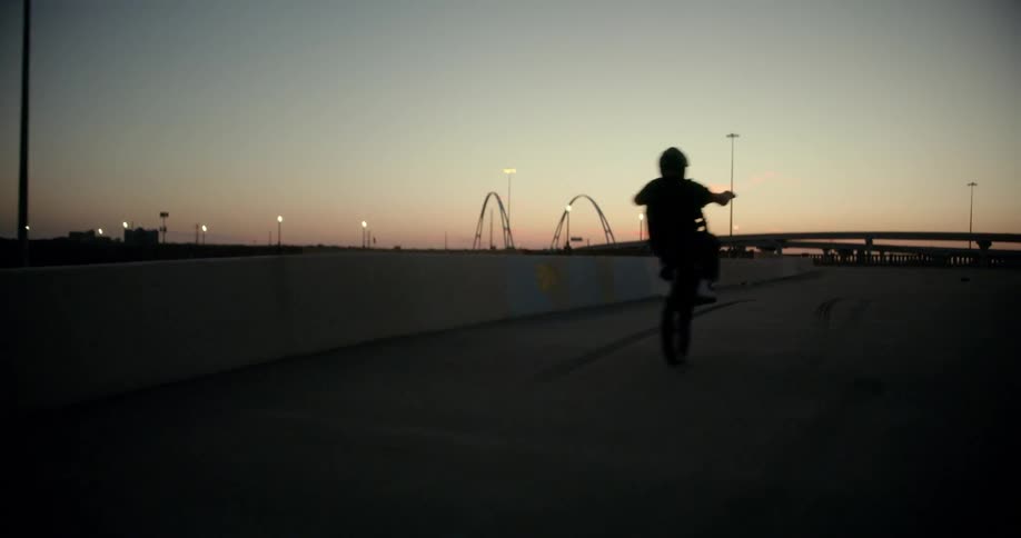 A person leaning his motorcycle on the deserted street