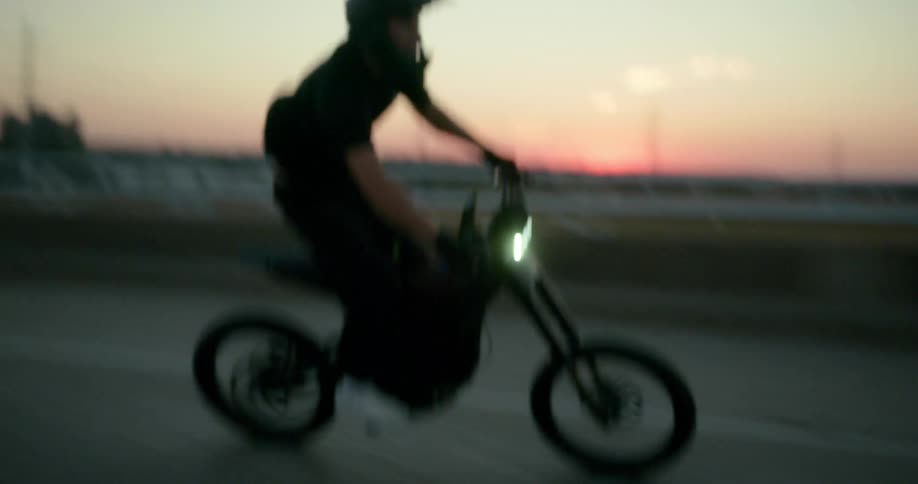 A man wearing a helmet is driving a small motorcycle on a street