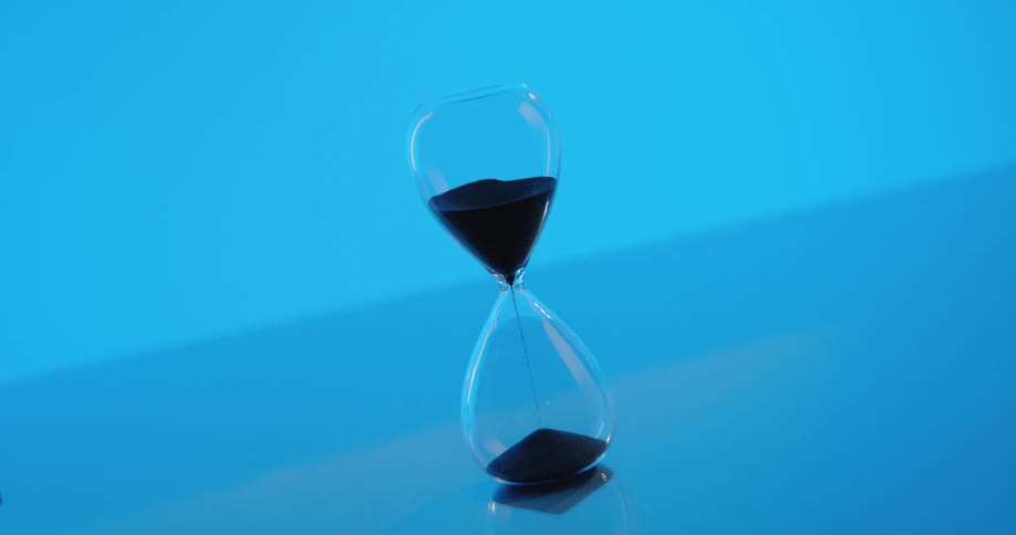 Hourglass with black sand falling