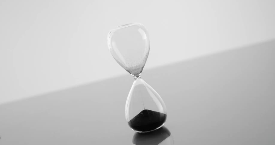 Sand pours through the hour glass
