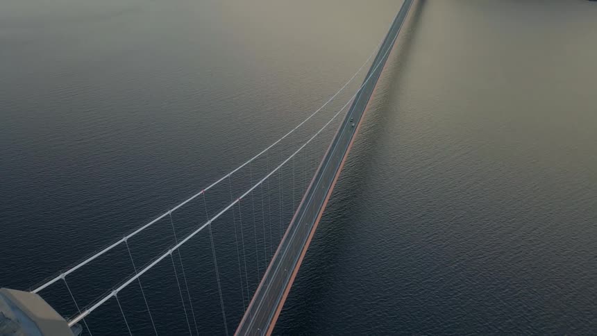 Aerial of the deserted bridge over the sea during sunset