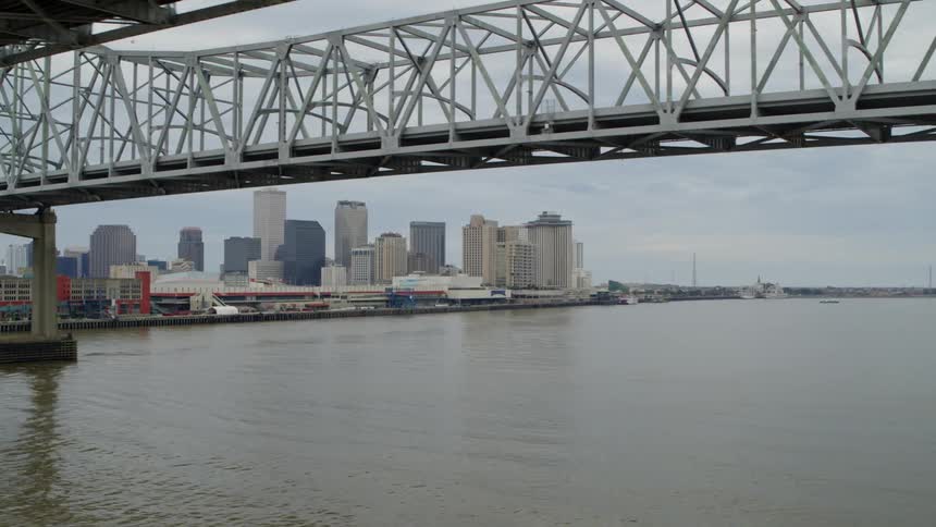 A bridge that passes over the water of a city that is on a coast
