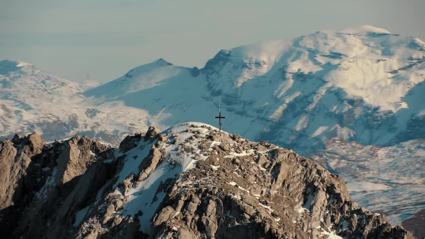 Aerial view of a small cross atop a mountain
