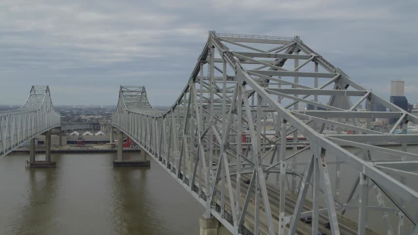 A view of two bridges above a lake on the outskirts of a metropolis