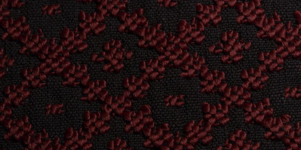 A black fabric with red embroidery