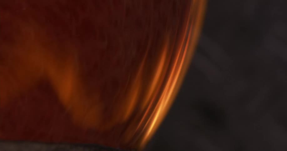 Glass blown piece turning over flames