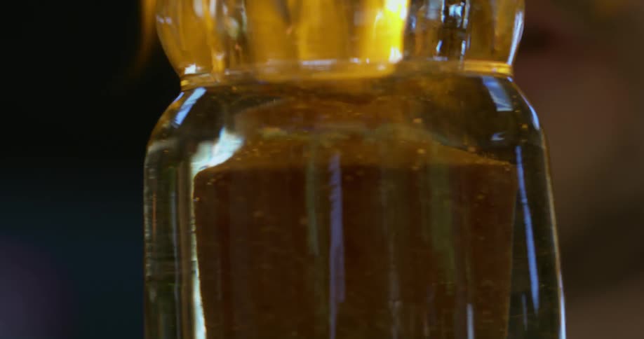 Glass with yellow liquid swirling