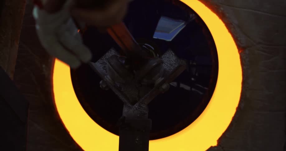 A view of an object being submerged in molten solder