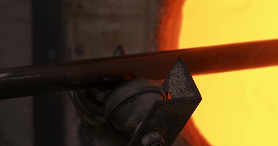 A metal rod is rotating in a hot and shiny place