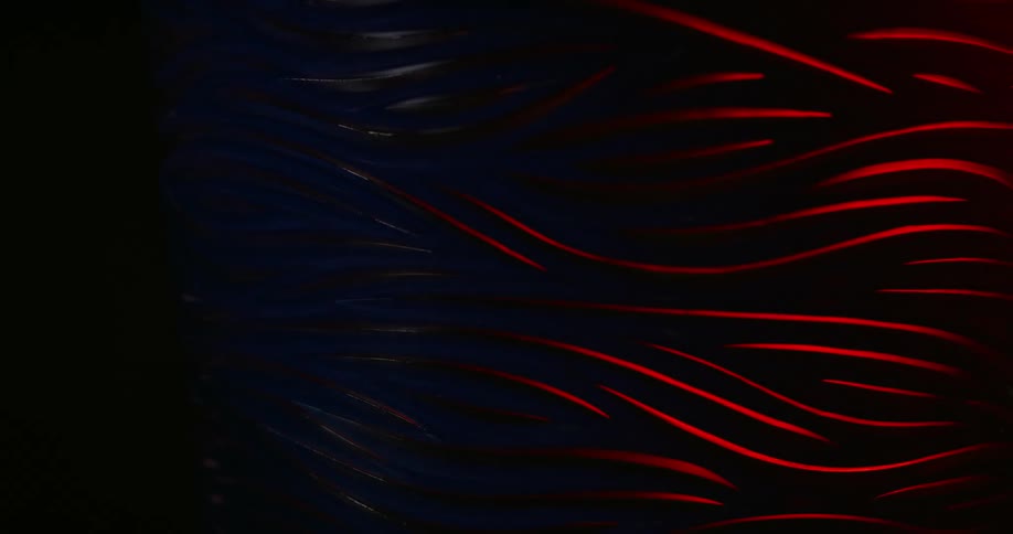 Red light beam with curved lines reveal in a dark abstract