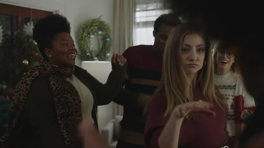 People dance indoors at holiday party