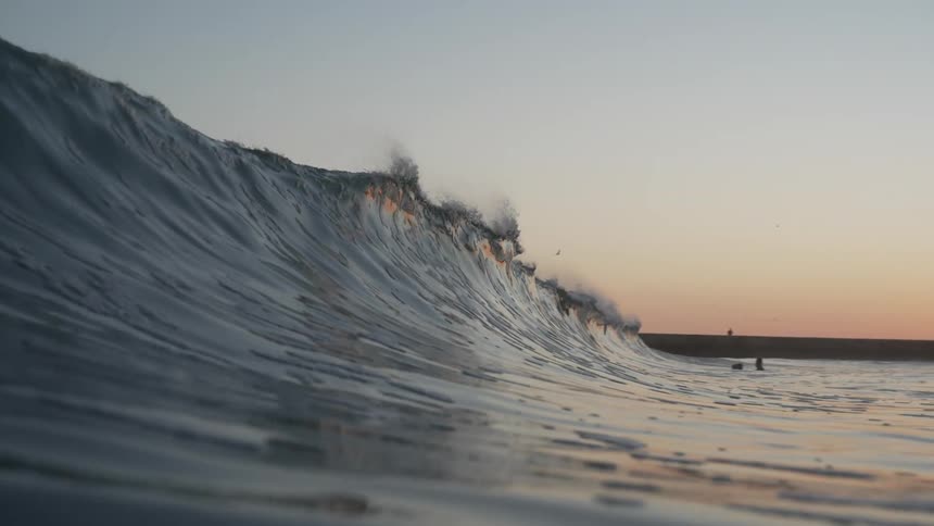 The waves from the ocean rise very high during dawn